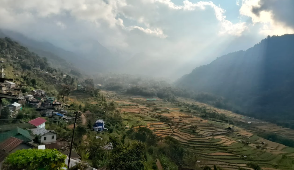Sunlit valley with terraced fields and houses of Khonoma