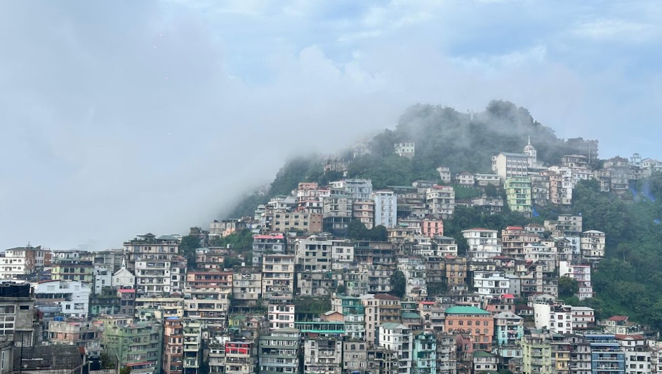 Aizawl houses stacked on a cloud-covered hillside