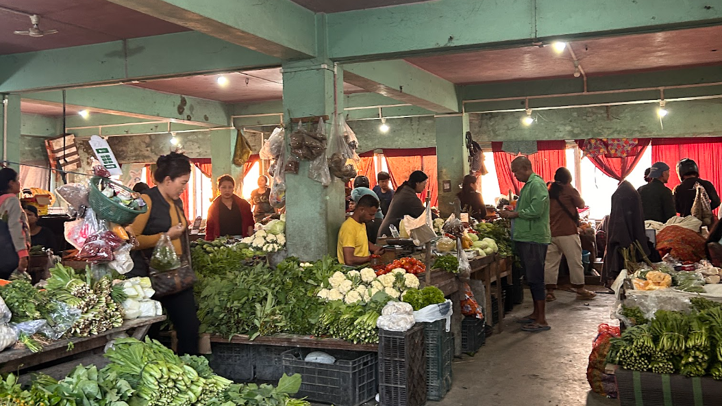 Shoppers and vegetable stalls inside a Mizoram market