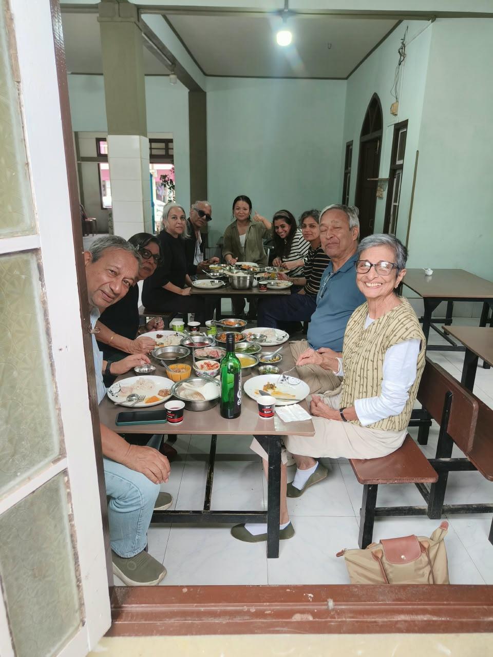 Group sharing a meal around a long table