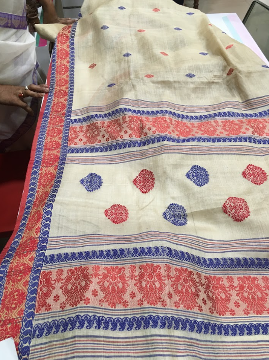 Handwoven Assamese mekhela chador with red and blue motifs