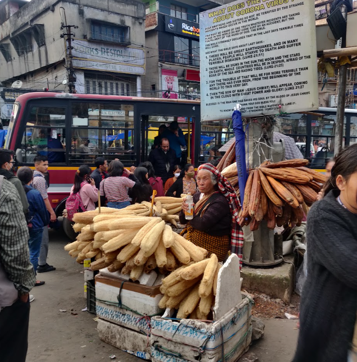Street vendor with bread loaves near Iewduh market, Shillong