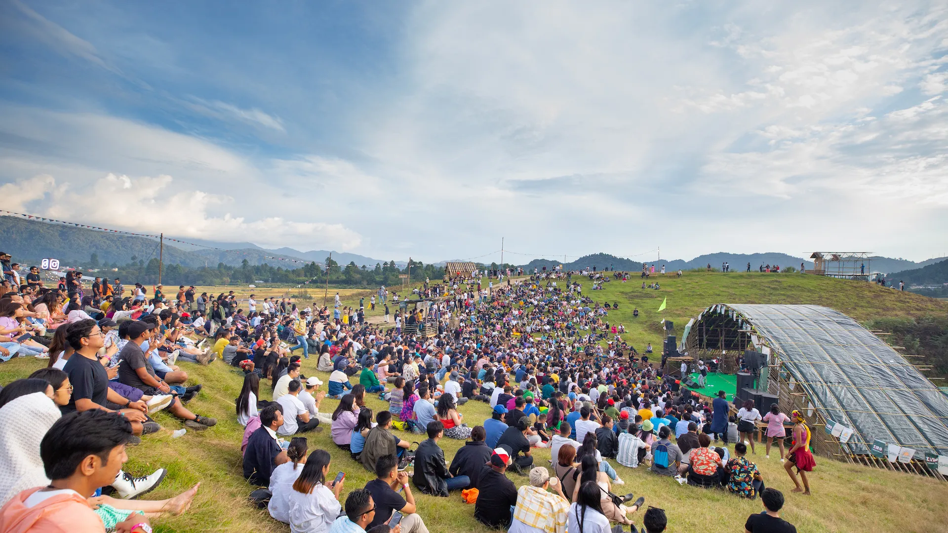 Crowd on a grassy hillside at the Ziro Festival of Music